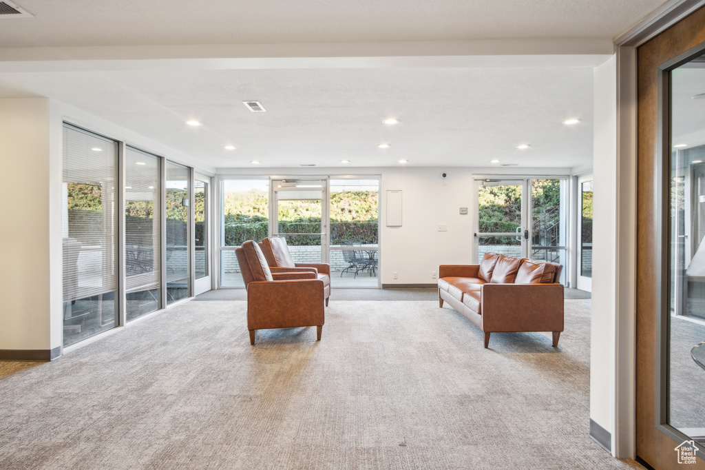 Living area with recessed lighting, carpet flooring, and plenty of natural light