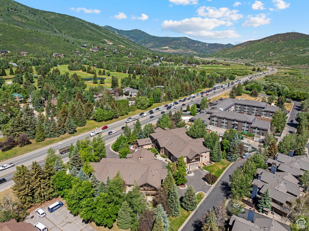 Aerial view of property and surrounding area featuring a mountain backdrop