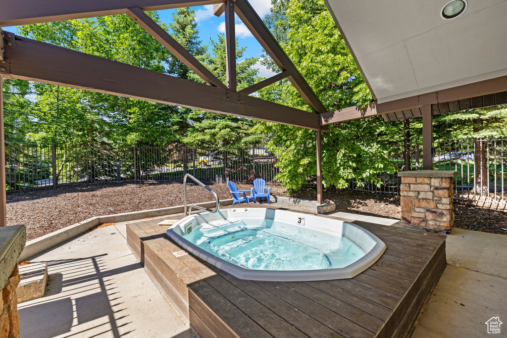 View of swimming pool featuring an in-ground hot tub