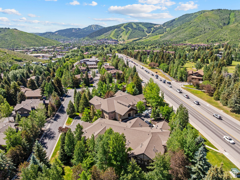 Aerial perspective of suburban area with mountains and a main thoroughfare