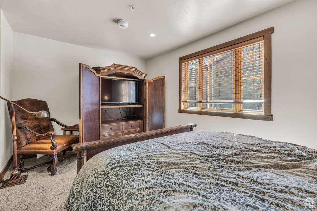 Carpeted bedroom featuring baseboards
