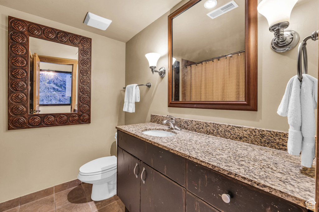 Bathroom with tile patterned flooring and vanity