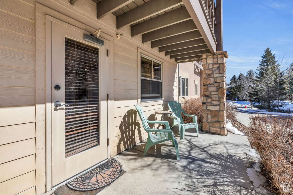 Snow covered patio featuring a porch