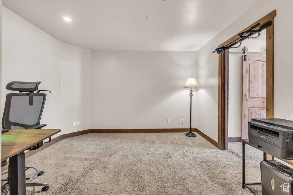 Unfurnished office featuring carpet floors and baseboards
