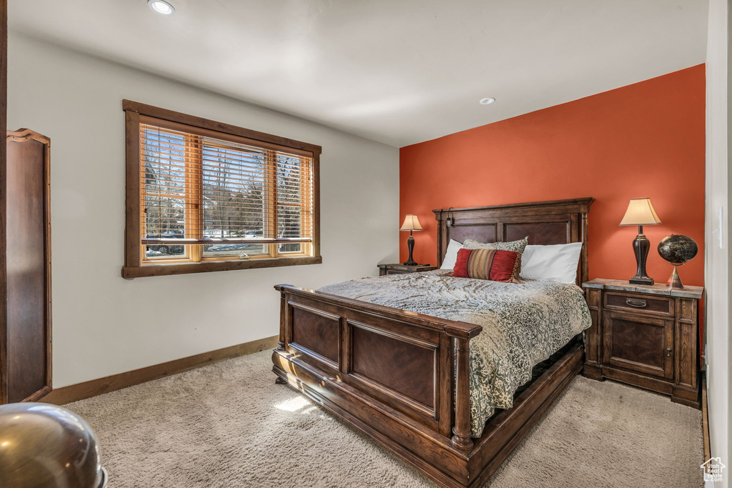 Bedroom with light carpet and recessed lighting