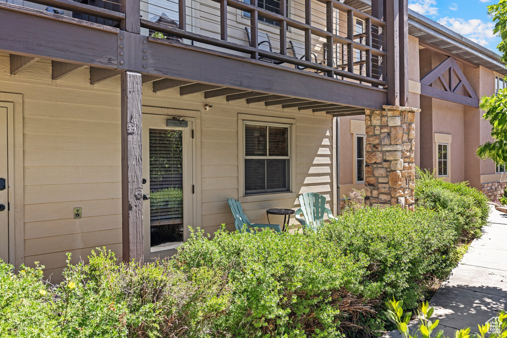 View of exterior entry with a balcony