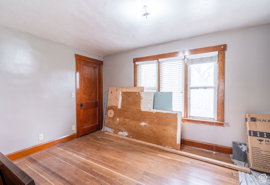 Empty room featuring hardwood / wood-style flooring