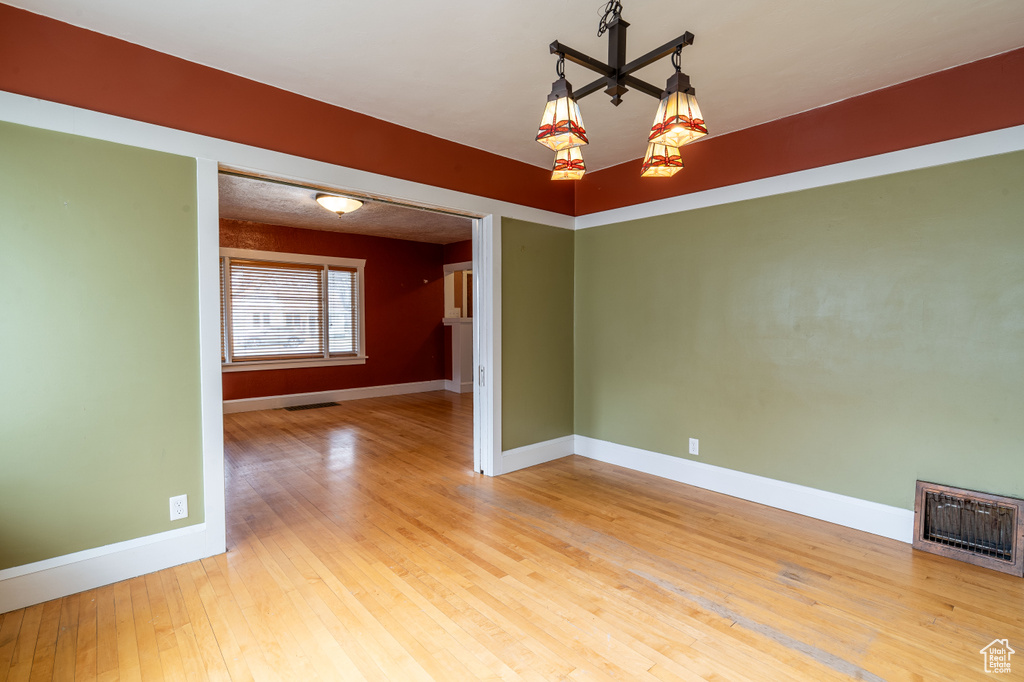 Empty room with hardwood / wood-style flooring