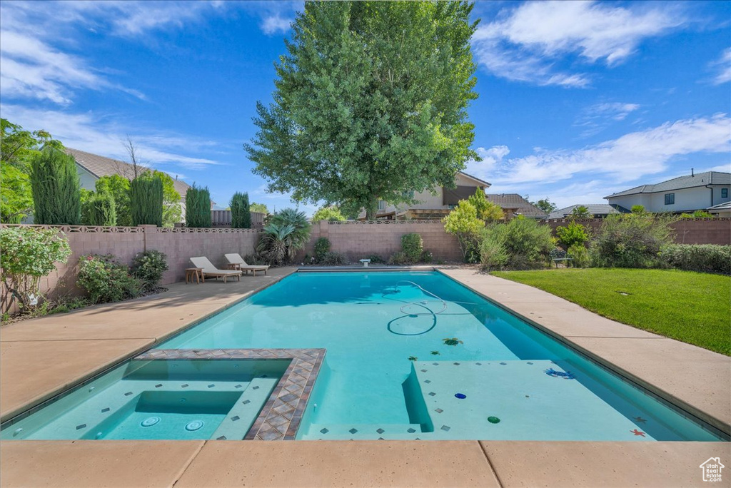 View of swimming pool with a patio and a pool with connected hot tub