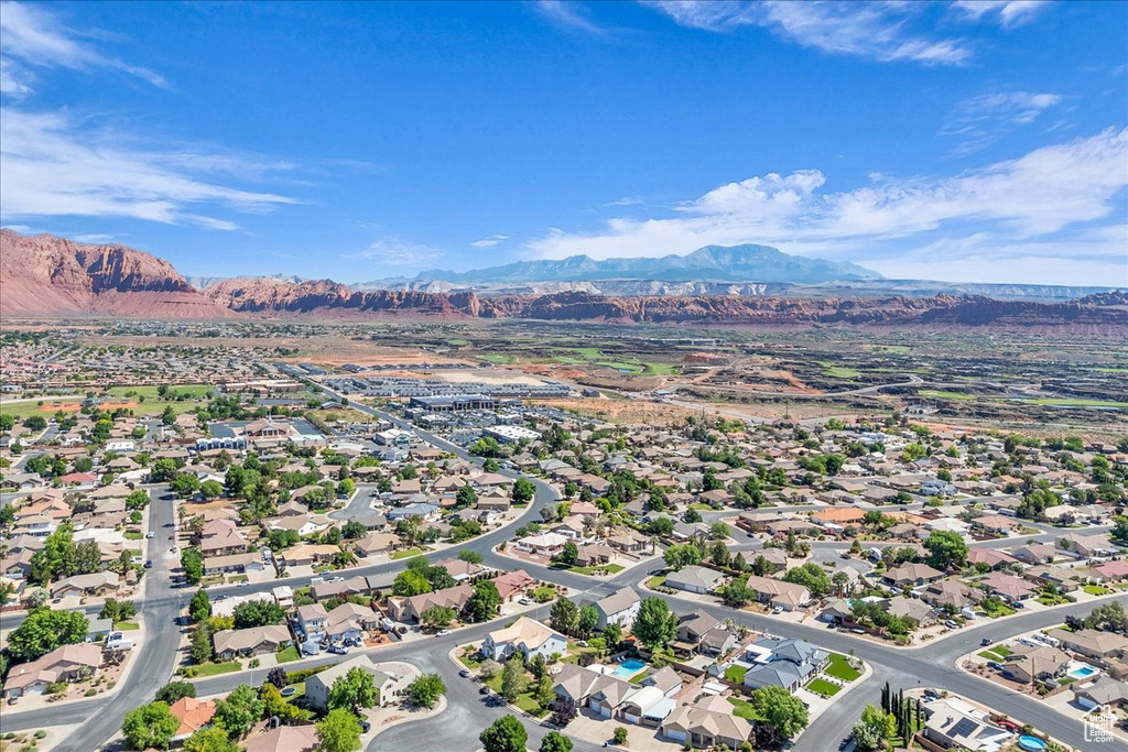 Aerial perspective of suburban area with a mountainous background