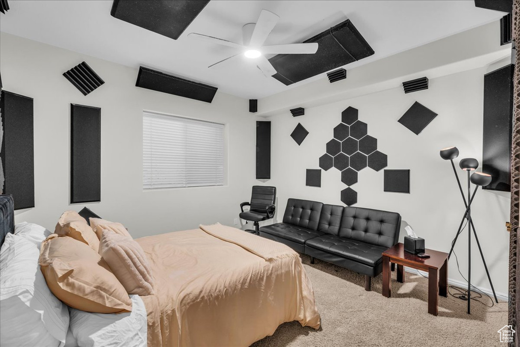 Carpeted bedroom with a ceiling fan