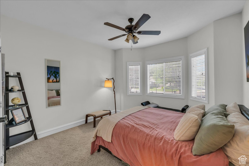 Bedroom featuring carpet, baseboards, and ceiling fan