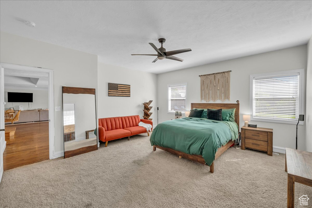 Bedroom with carpet, a ceiling fan, and baseboards