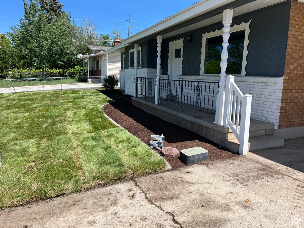 View of property exterior featuring a porch and brick siding