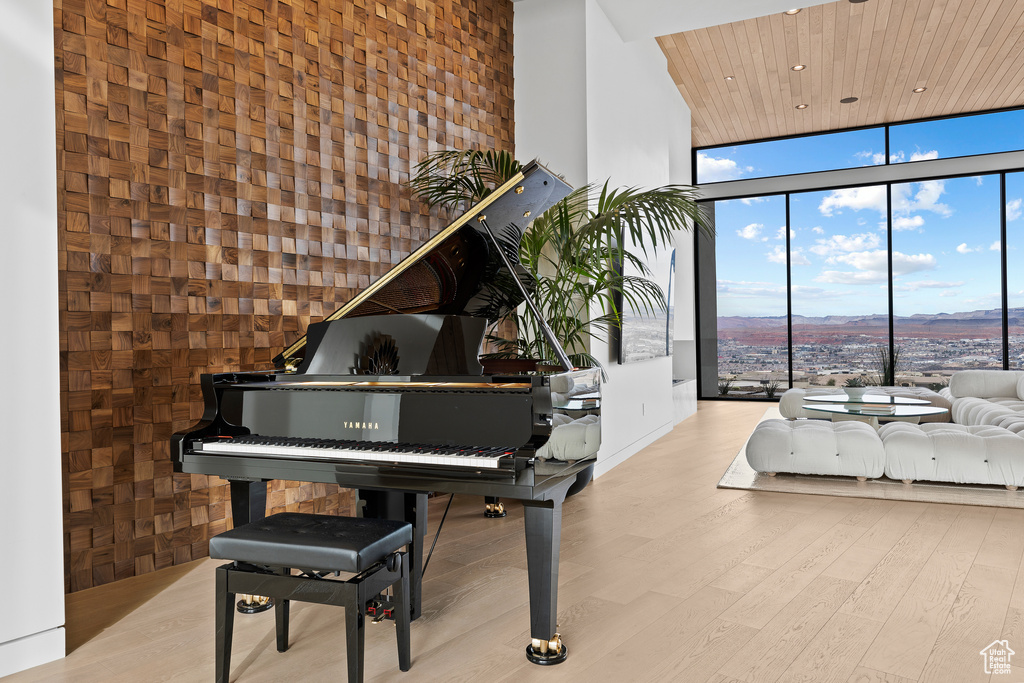 Sitting room with recessed lighting, a high ceiling, wood finished floors, wood ceiling, and expansive windows