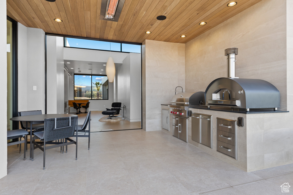 View of patio / terrace featuring outdoor dining area, an outdoor kitchen, and a grill