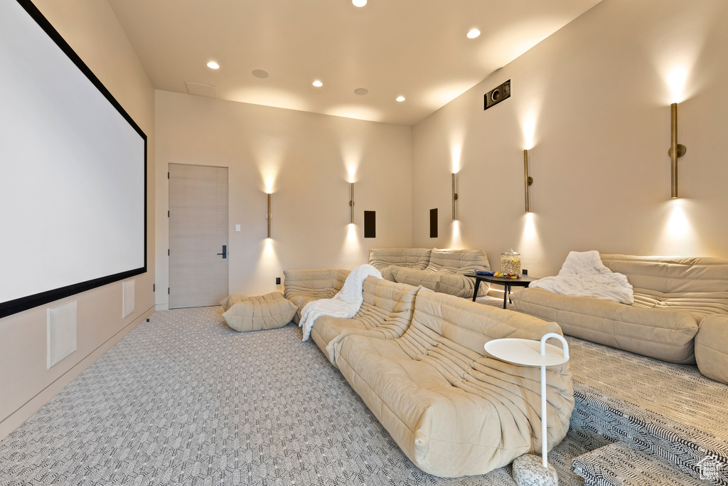 Home theater room with recessed lighting and light carpet