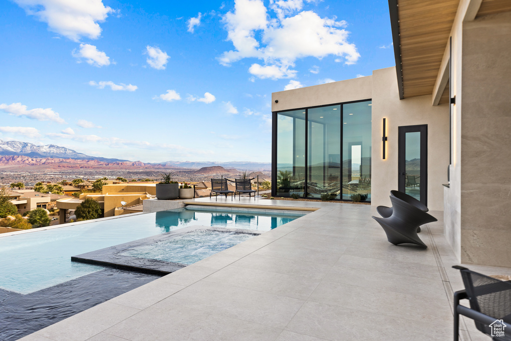 View of pool featuring an infinity pool and a mountain view