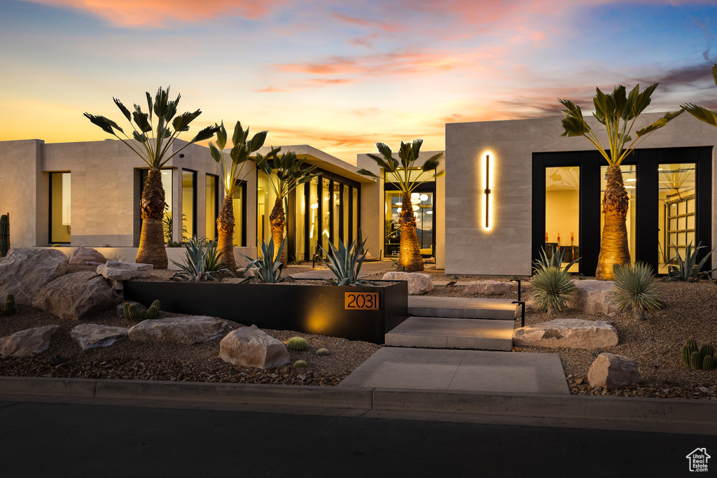 Pueblo revival-style home featuring stucco siding