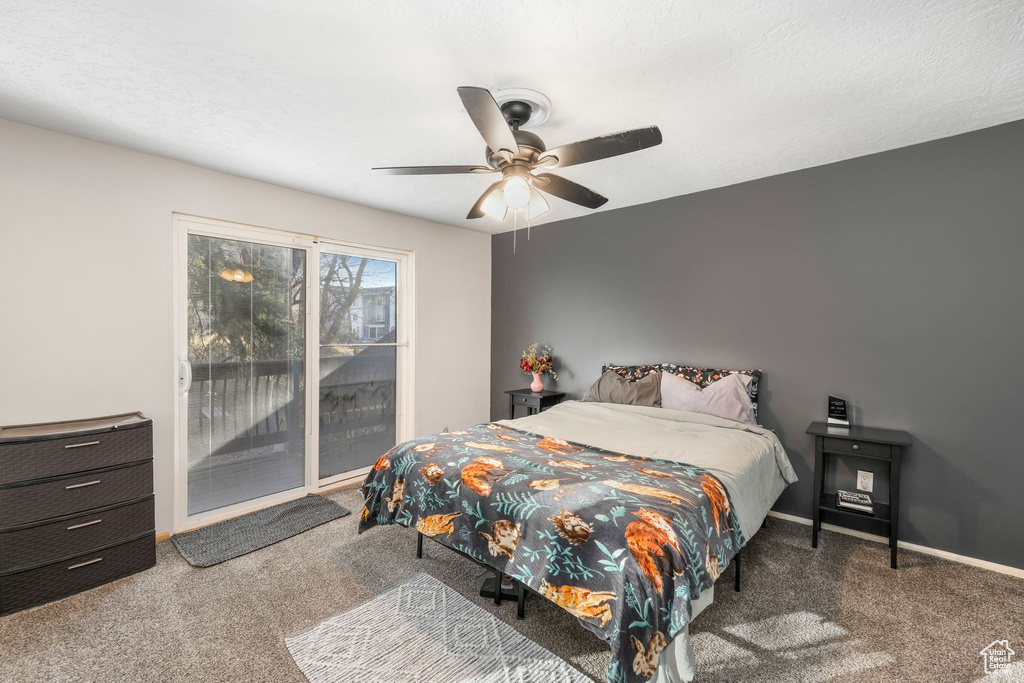 Carpeted bedroom featuring access to exterior, baseboards, and a ceiling fan