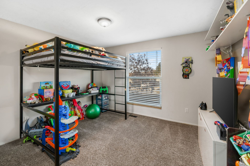 Bedroom featuring carpet floors and baseboards