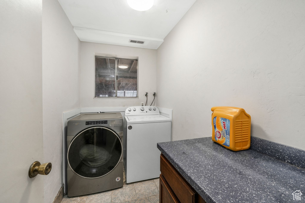 Laundry area with laundry area, visible vents, and washer and clothes dryer