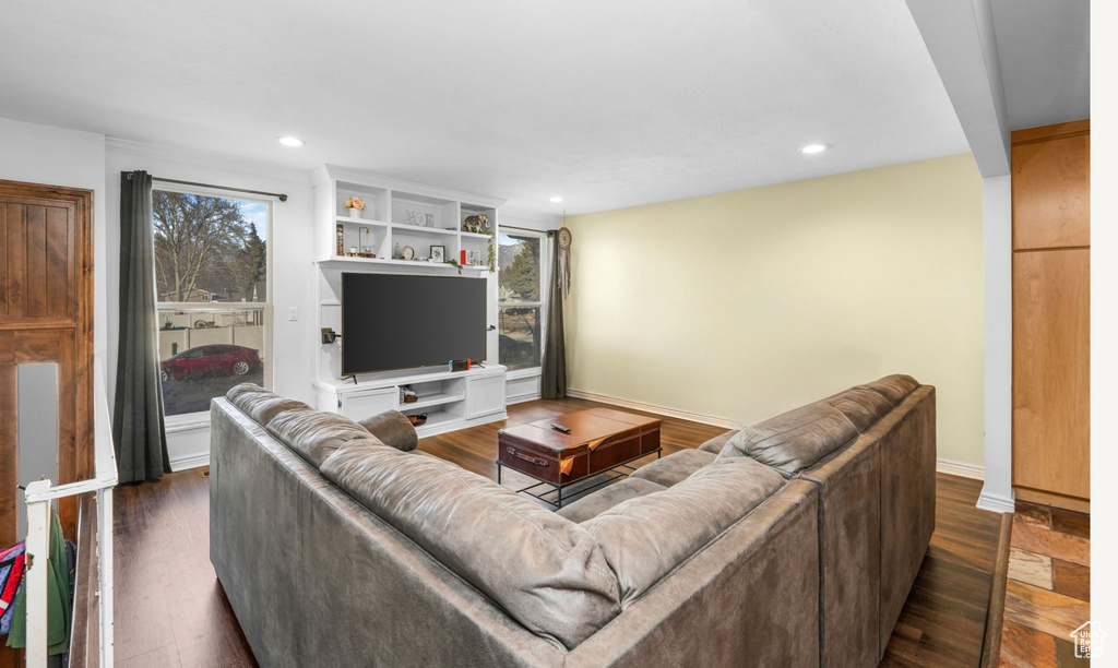 Living area with baseboards, dark wood finished floors, and recessed lighting