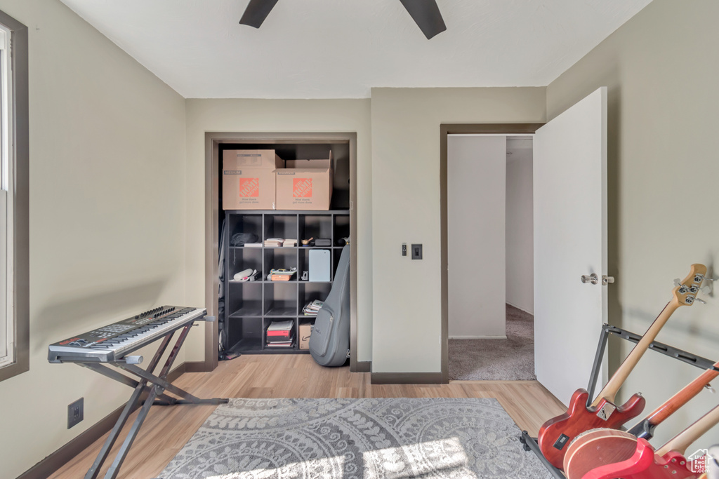 Bedroom featuring ceiling fan, wood finished floors, and baseboards