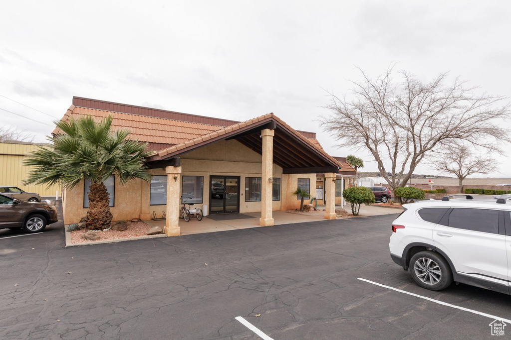 View of building exterior featuring uncovered parking