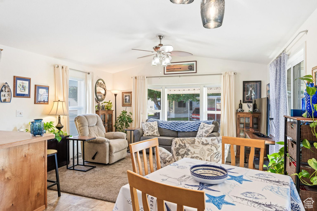 Dining space featuring lofted ceiling and a ceiling fan