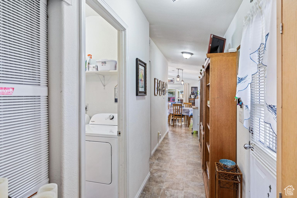 Corridor featuring washer / dryer and baseboards