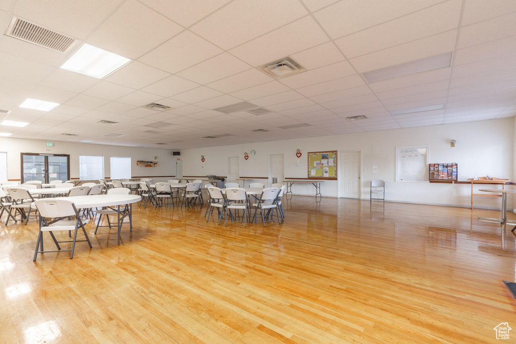 Dining space featuring wood finished floors and a drop ceiling