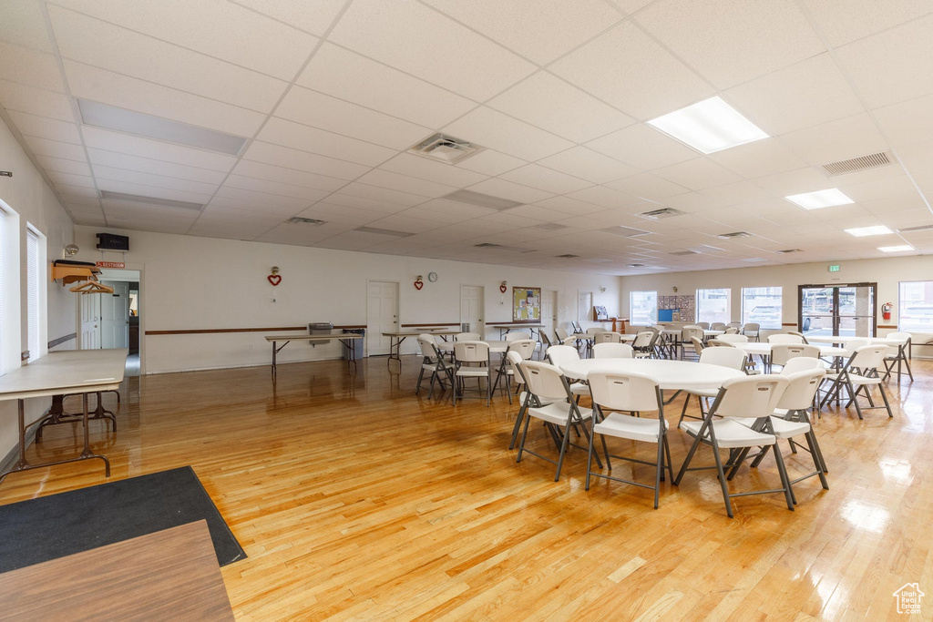 Dining area with light wood-style flooring and a drop ceiling
