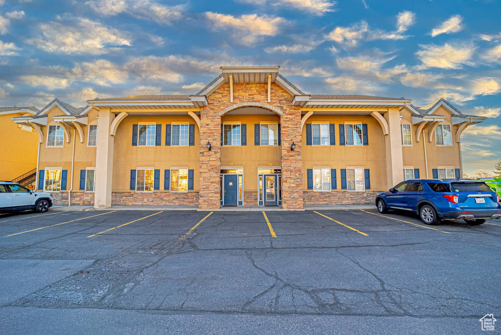 Property at dusk with uncovered parking