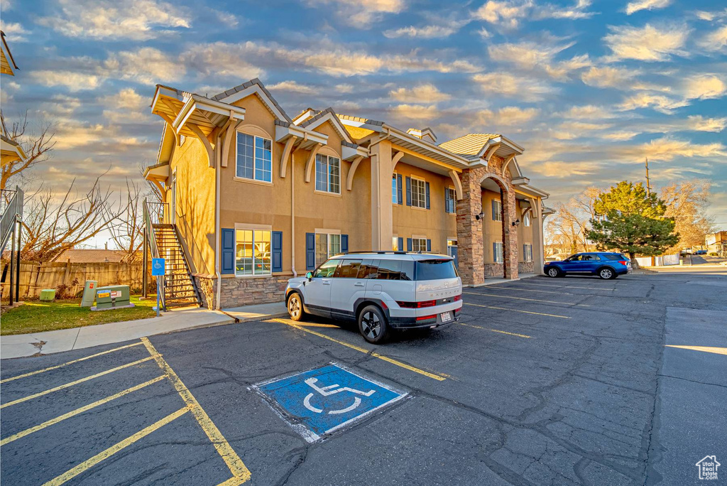 Exterior space with stairs and uncovered parking
