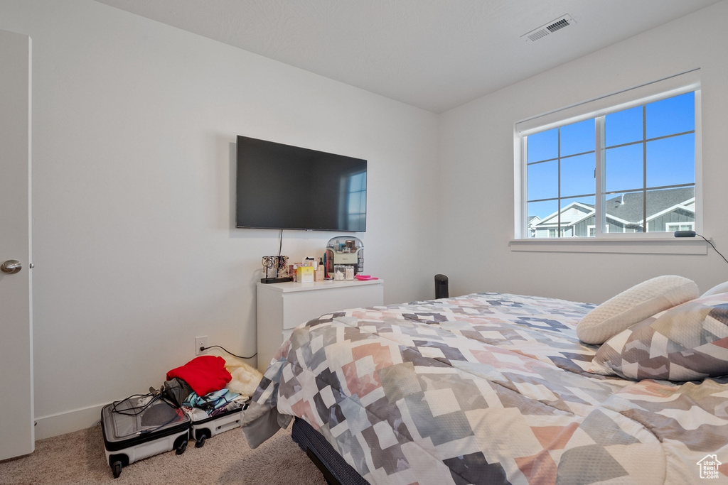 Carpeted bedroom with visible vents