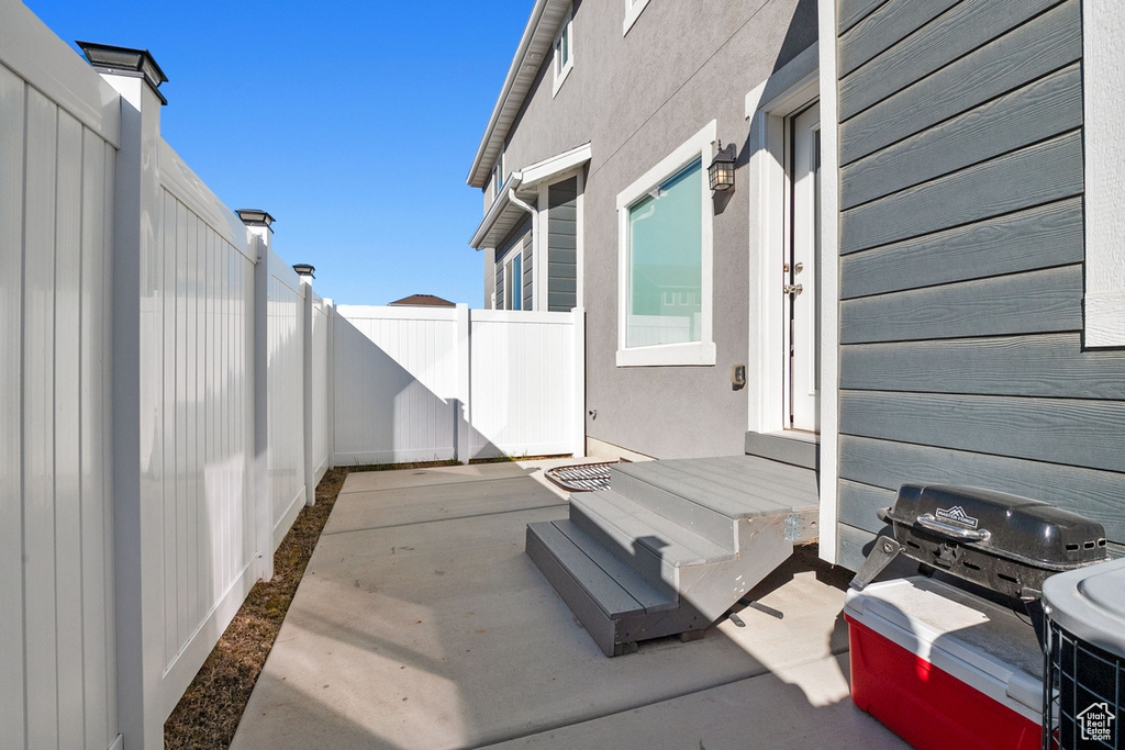 View of patio featuring fence