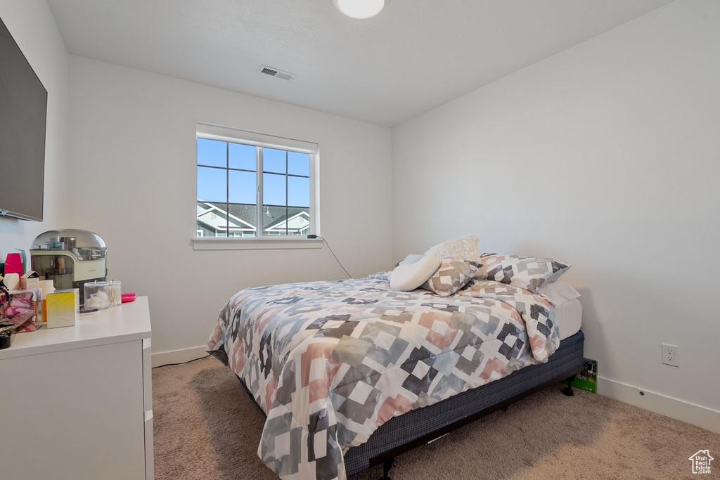 Bedroom featuring baseboards, visible vents, and carpet flooring