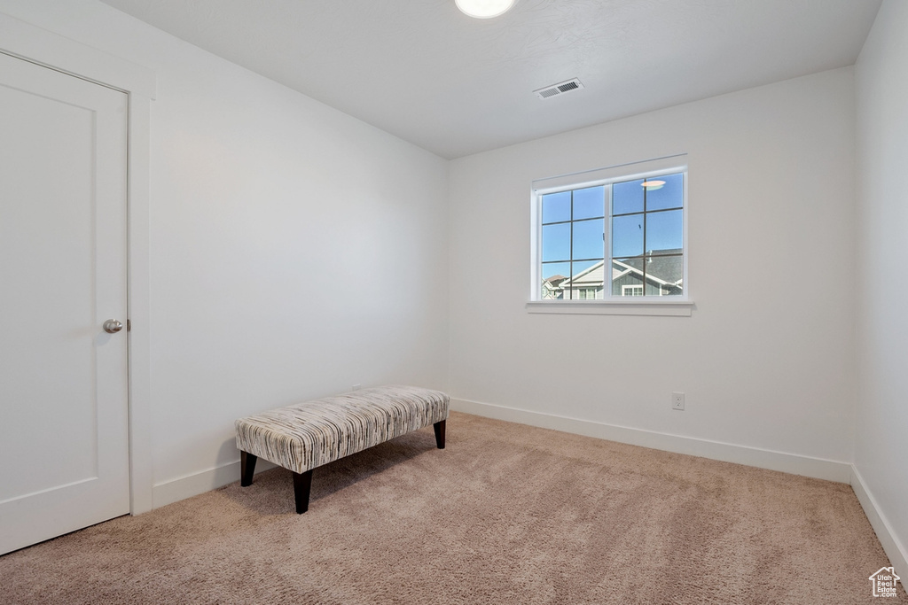 Sitting room with baseboards, visible vents, and carpet flooring