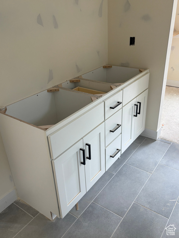 Bathroom featuring tile patterned floors and baseboards
