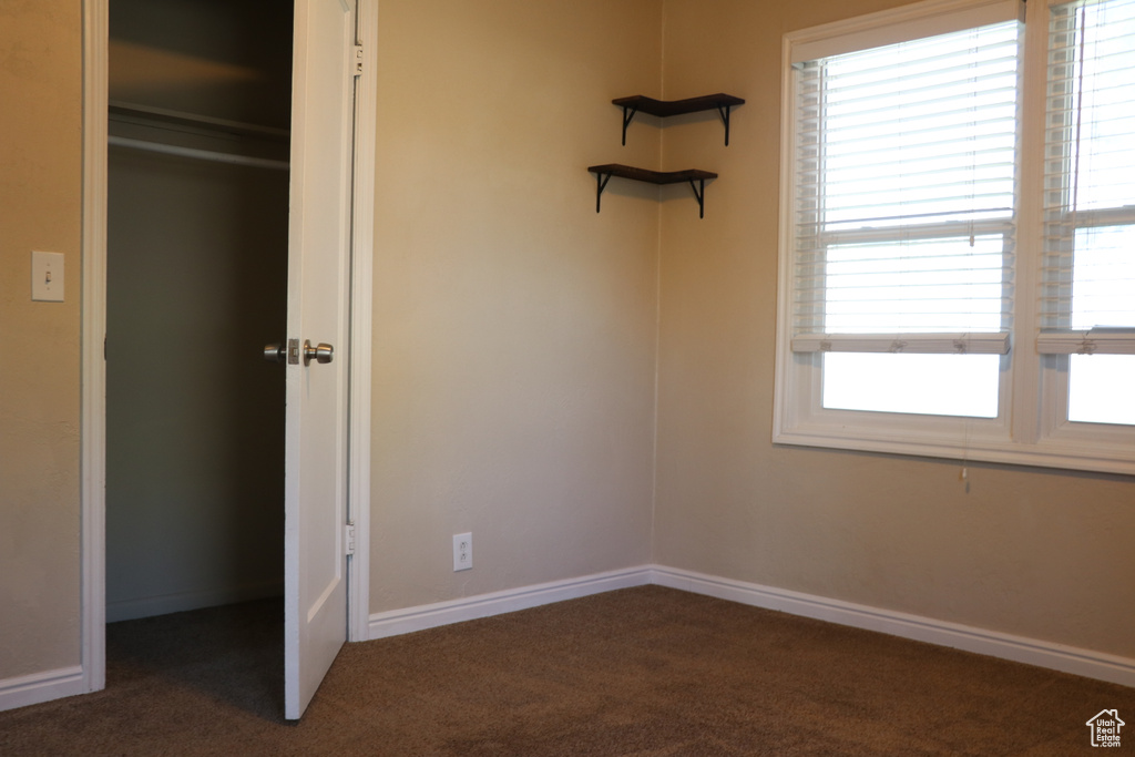 Unfurnished bedroom with carpet floors and baseboards