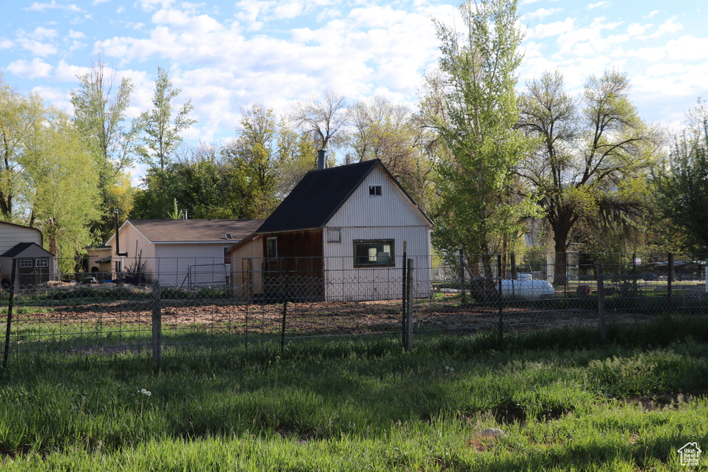 View of front of home featuring fence