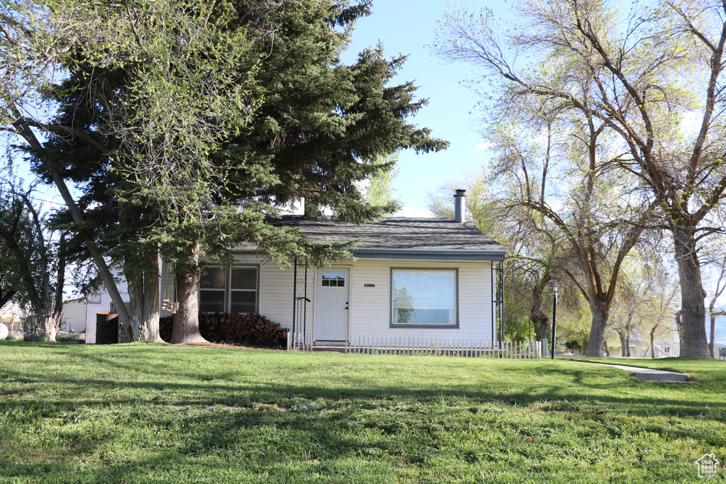 View of front of home featuring a front yard and a chimney