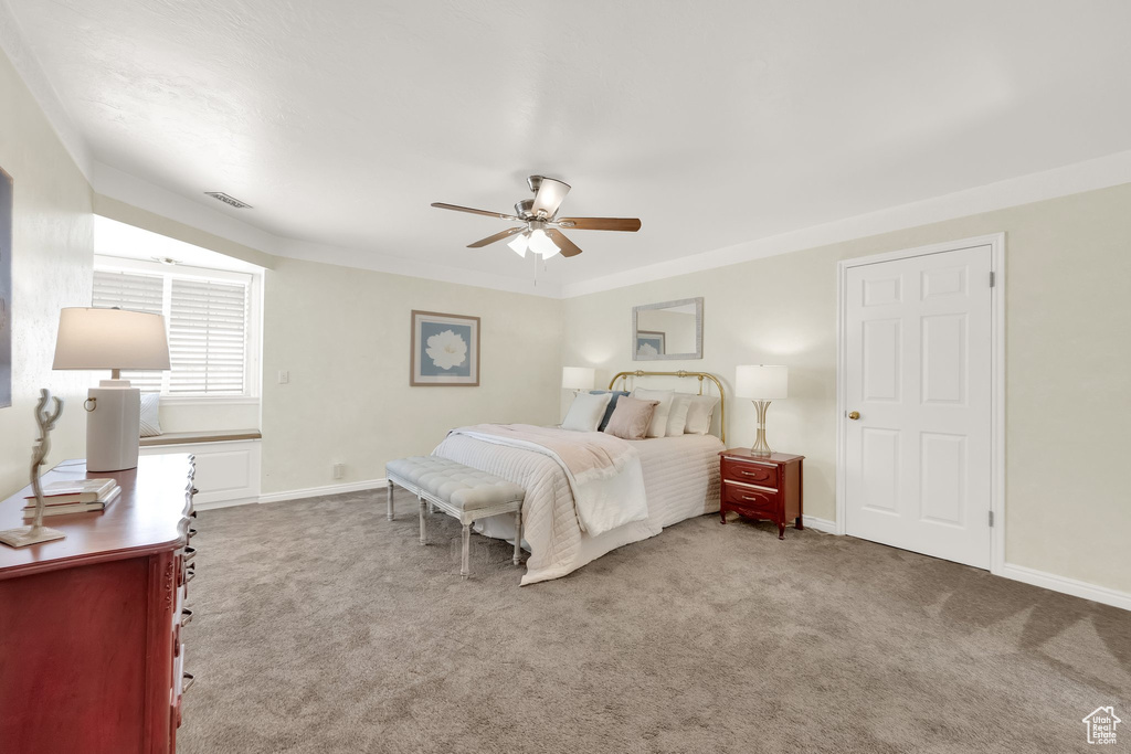Carpeted bedroom with baseboards, ceiling fan, and visible vents