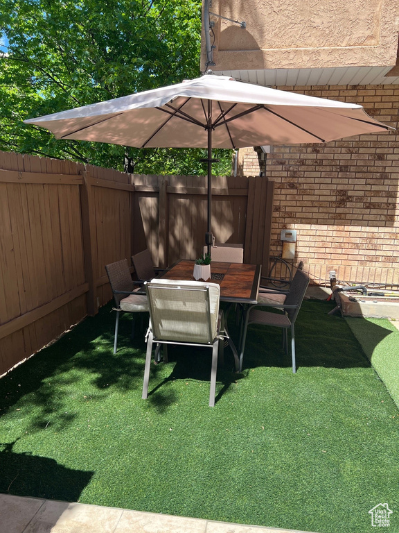 View of yard featuring fence and outdoor dining area