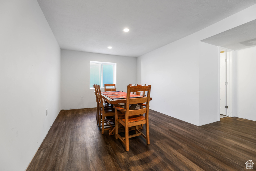 Dining room featuring dark wood-style flooring and recessed lighting