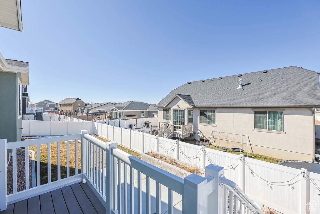 Wooden terrace featuring a fenced backyard and a residential view
