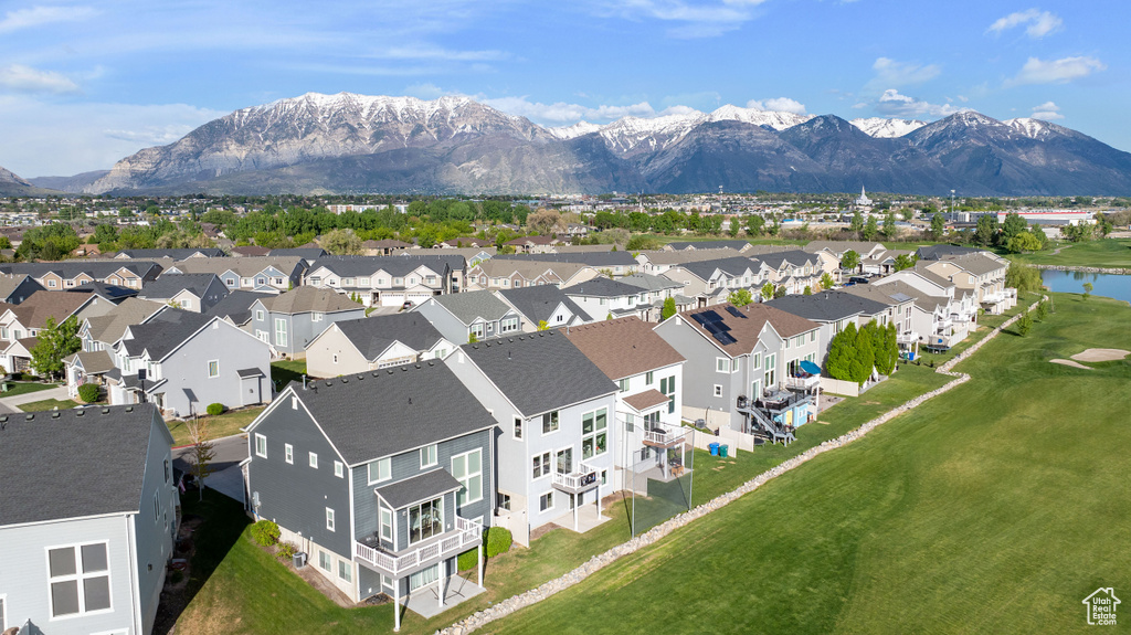Drone / aerial view featuring view of golf course, a residential view, and a water and mountain view