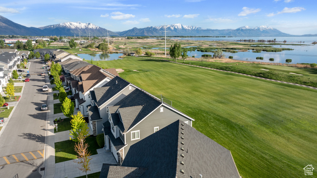Aerial view with a water and mountain view and golf course view