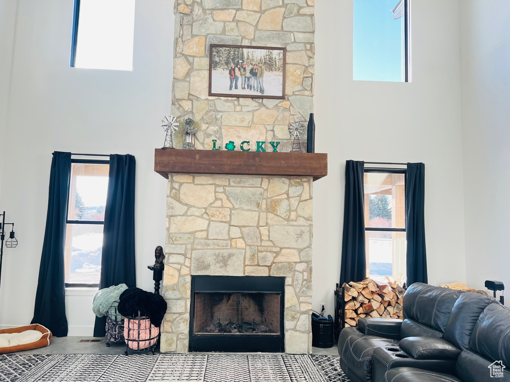 Living room with a stone fireplace and a towering ceiling
